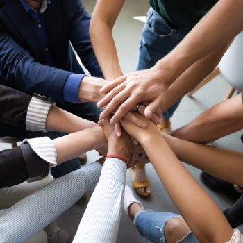 Top,Close,Up,Lot,Of,Hands,Stacked,Together,As,Symbol